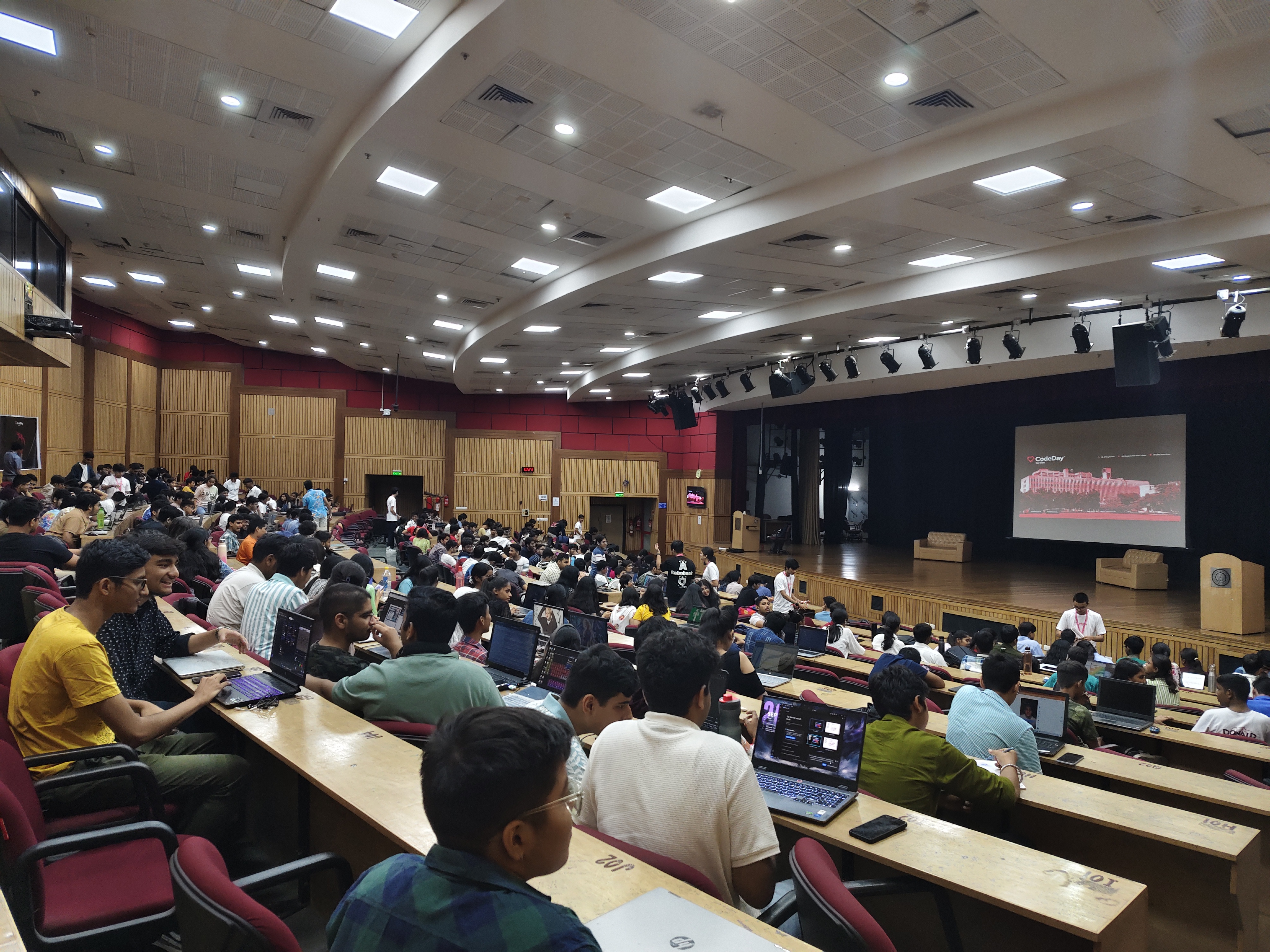 Participants working on laptops in the IIT Delhi auditorium during the hackathon